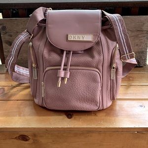 DKNY backpack, red inside, A+ condition, gold embellishments.